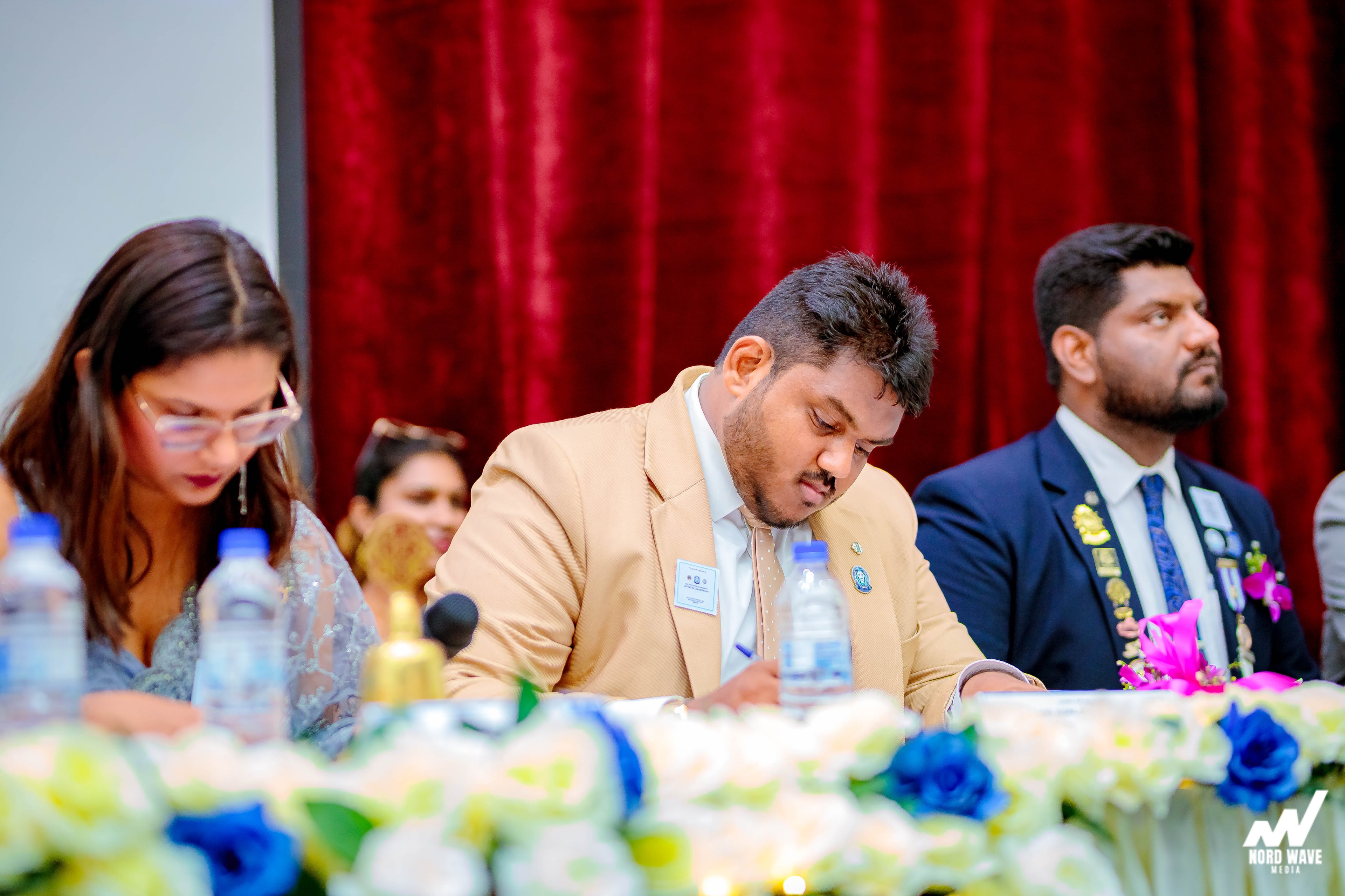 The head table at work during the ceremony